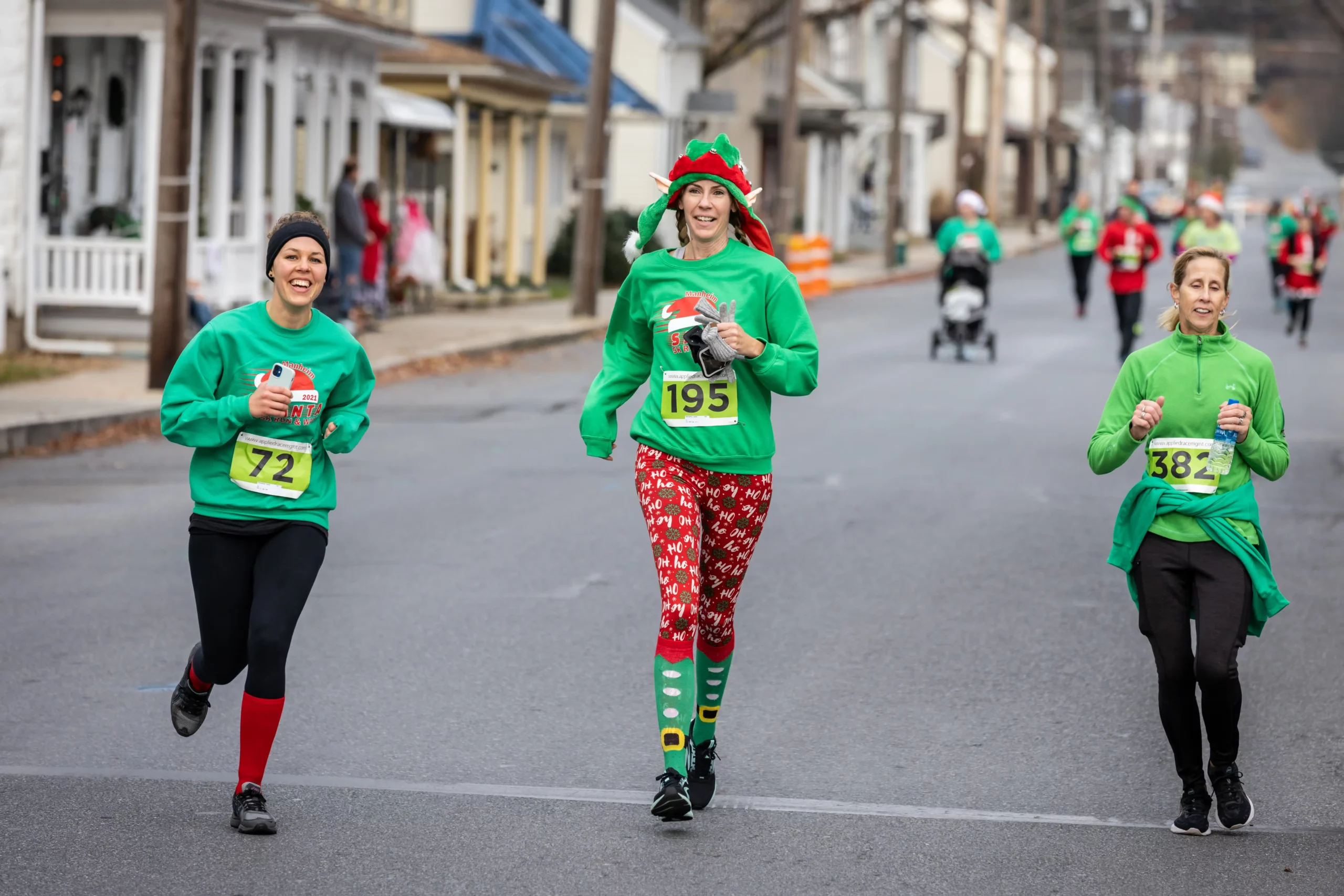 Participants running along the course, in holiday attire, during the Santa 5K Run & Walk.
