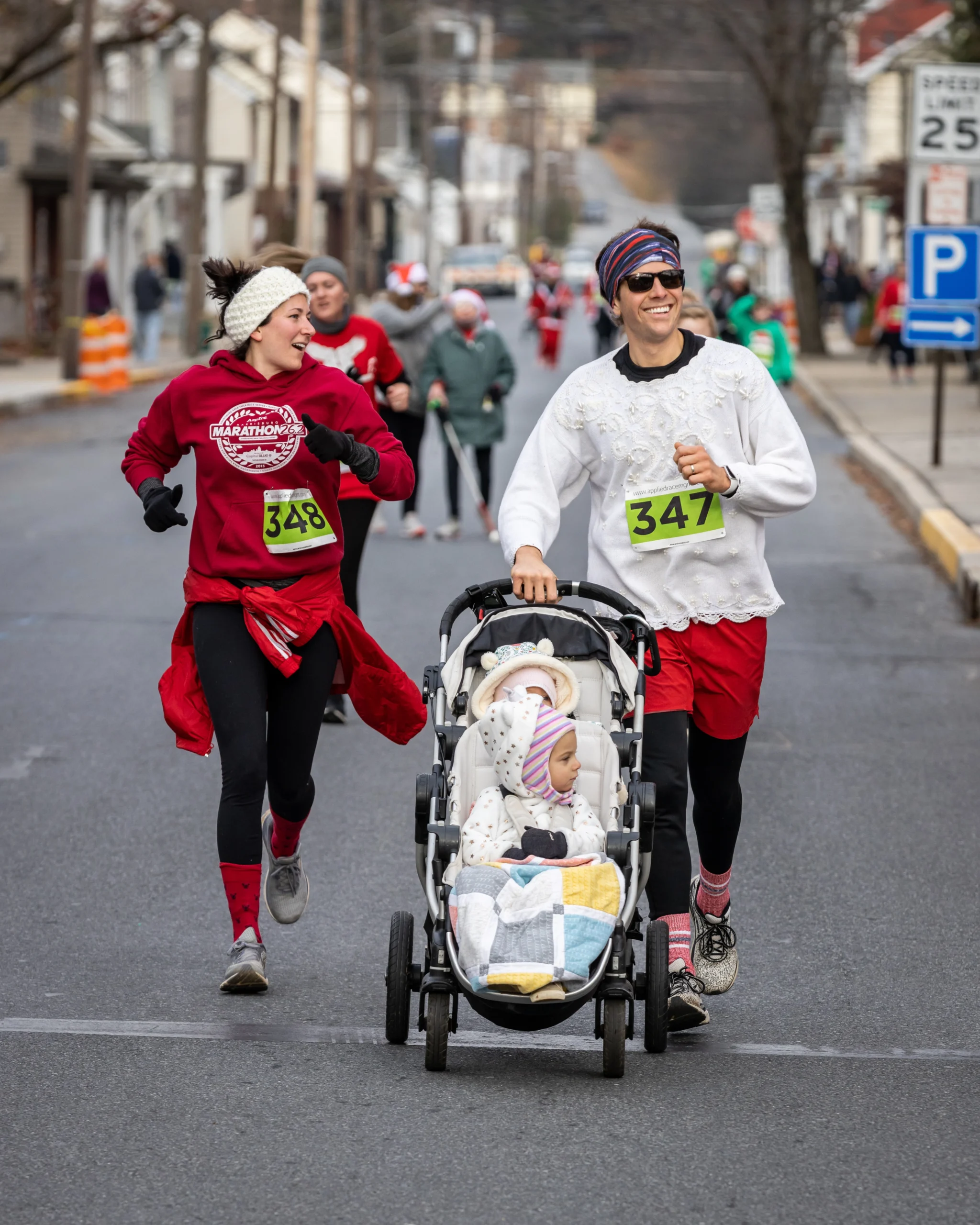 Participants running with a stroller during the Santa 5K Run & Walk.